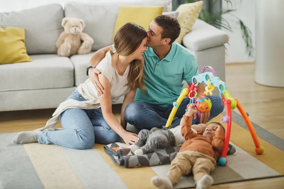 Parents and children hugging at home